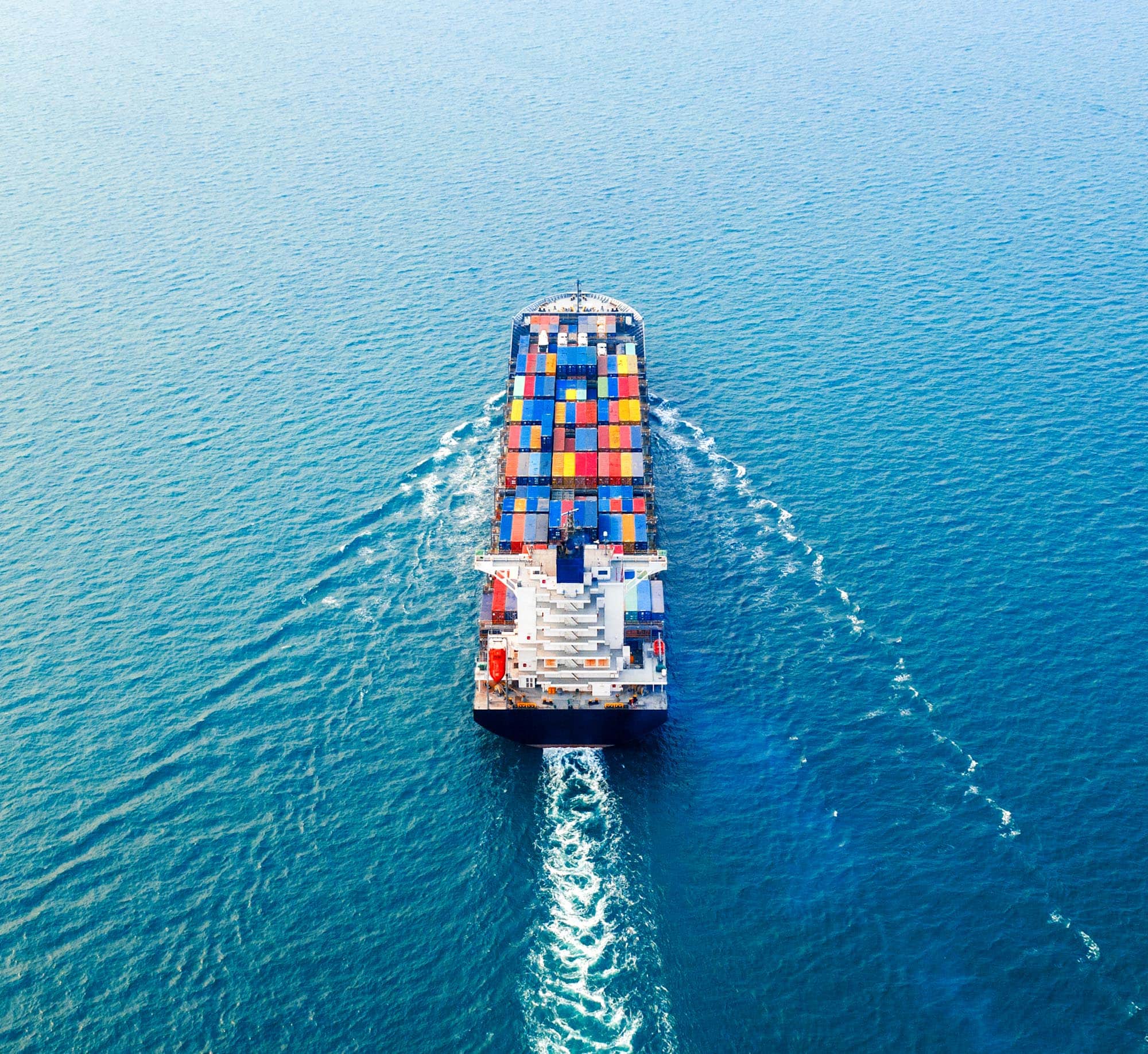 Aerial view of container cargo ship in sea.